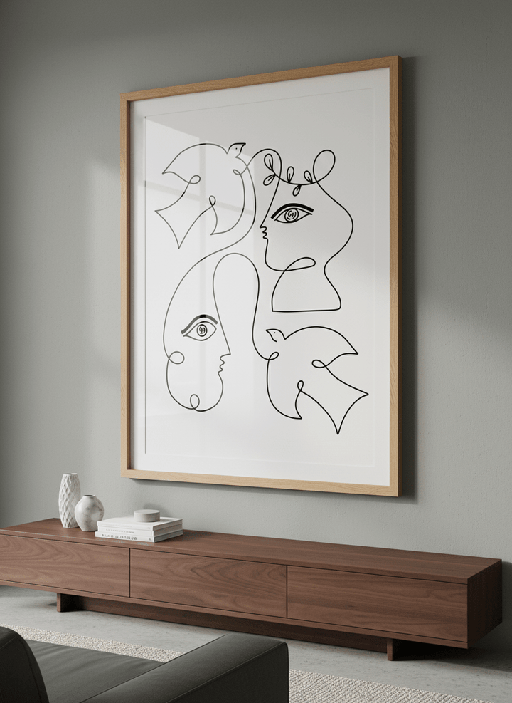 Modern wall art styled above a sofa in a neutral living room