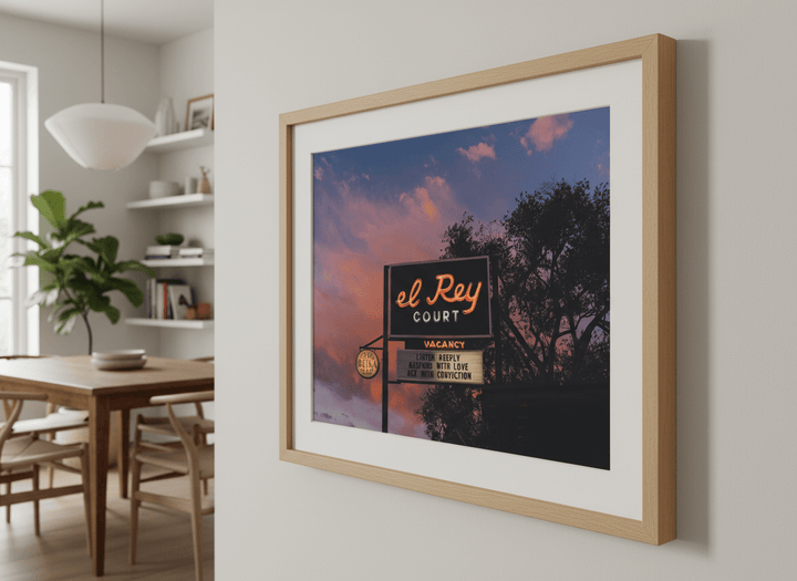 Wall art styled above a dining table in a contemporary home