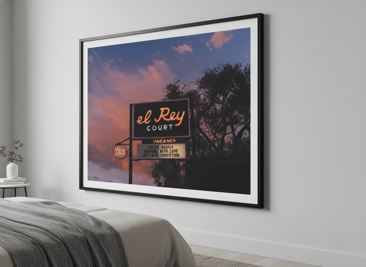 Minimalist artwork displayed in a calm, light-filled bedroom interior