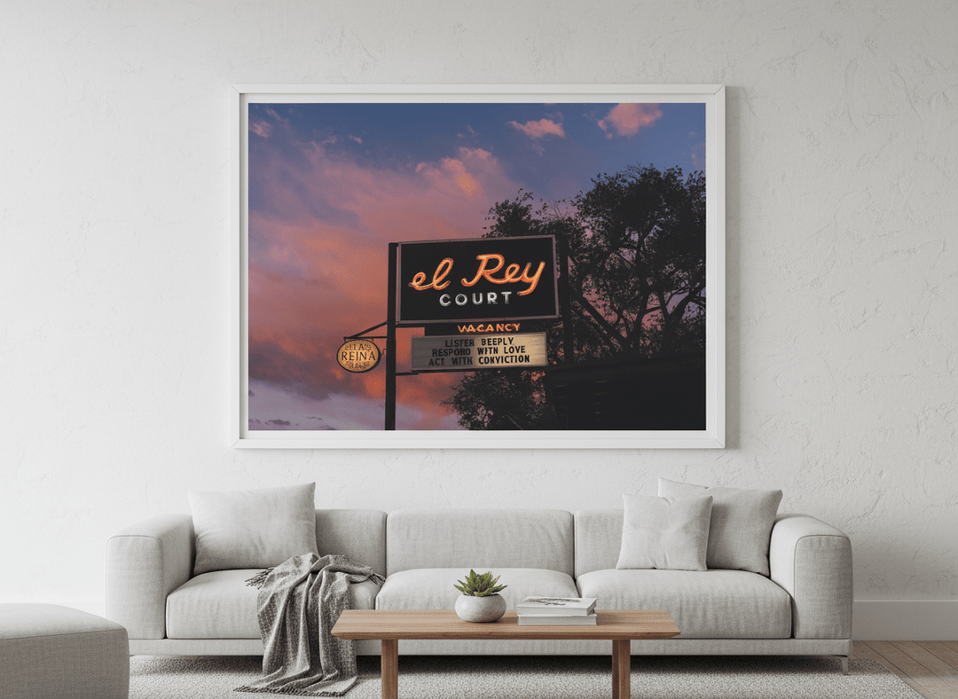 Modern wall art styled above a sofa in a neutral living room