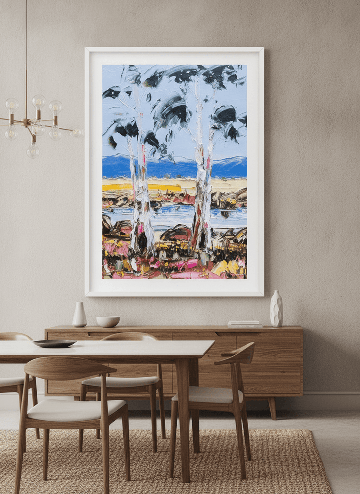 Wall art styled above a dining table in a contemporary home