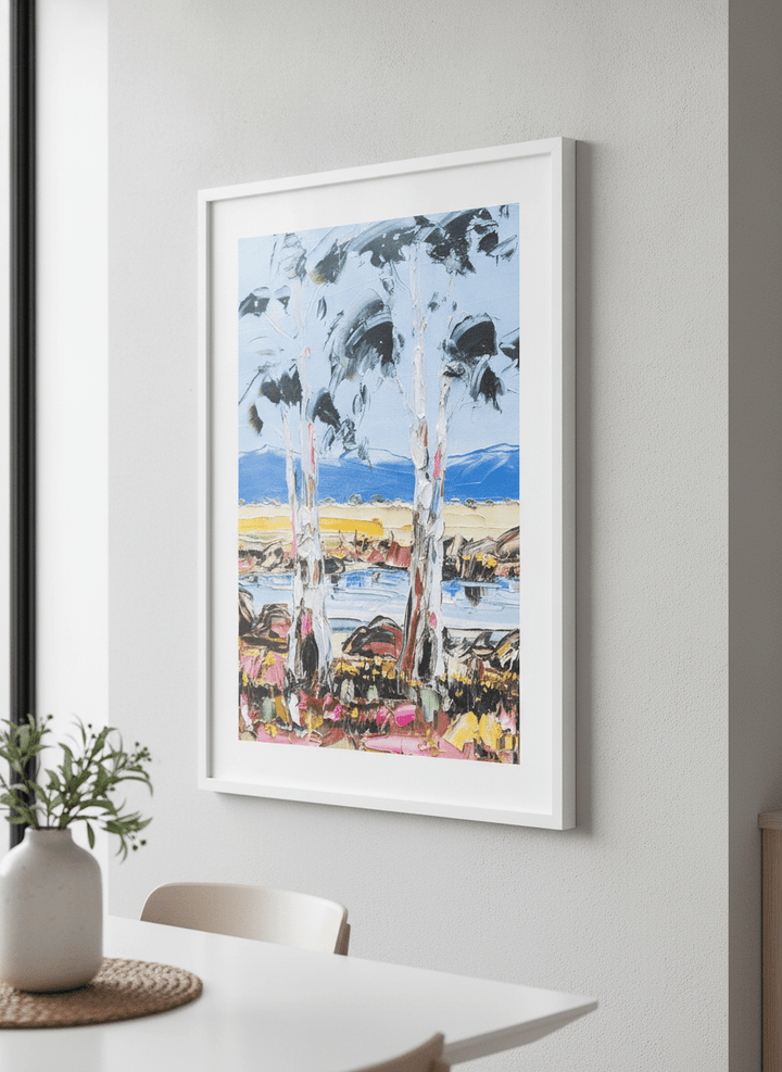 Wall art styled above a dining table in a contemporary home