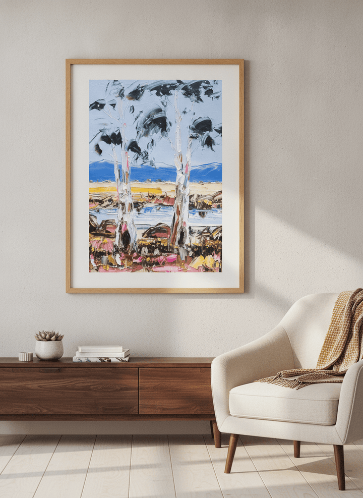 Modern wall art styled above a sofa in a neutral living room