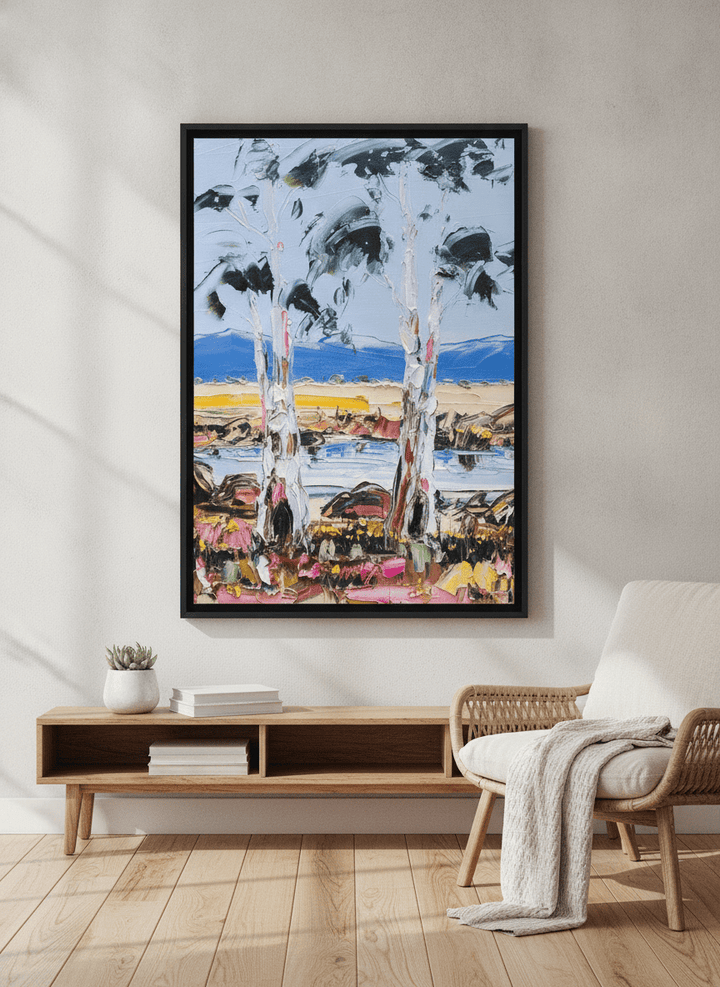 Modern wall art styled above a sofa in a neutral living room