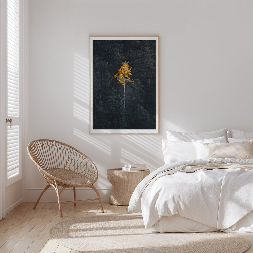 Modern bedroom with a bed, chair, and artwork on the wall.