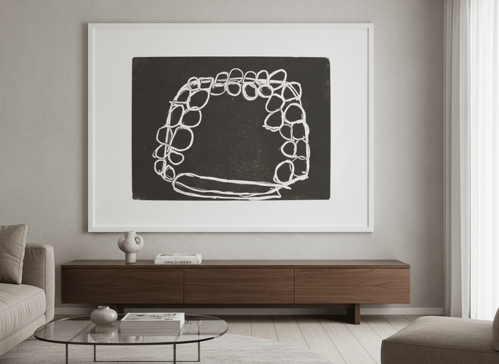 Modern wall art styled above a sofa in a neutral living room