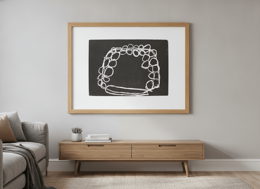 Modern wall art styled above a sofa in a neutral living room
