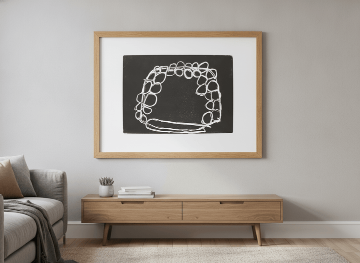 Modern wall art styled above a sofa in a neutral living room
