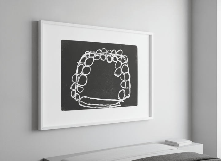 Minimalist artwork displayed in a calm, light-filled bedroom interior
