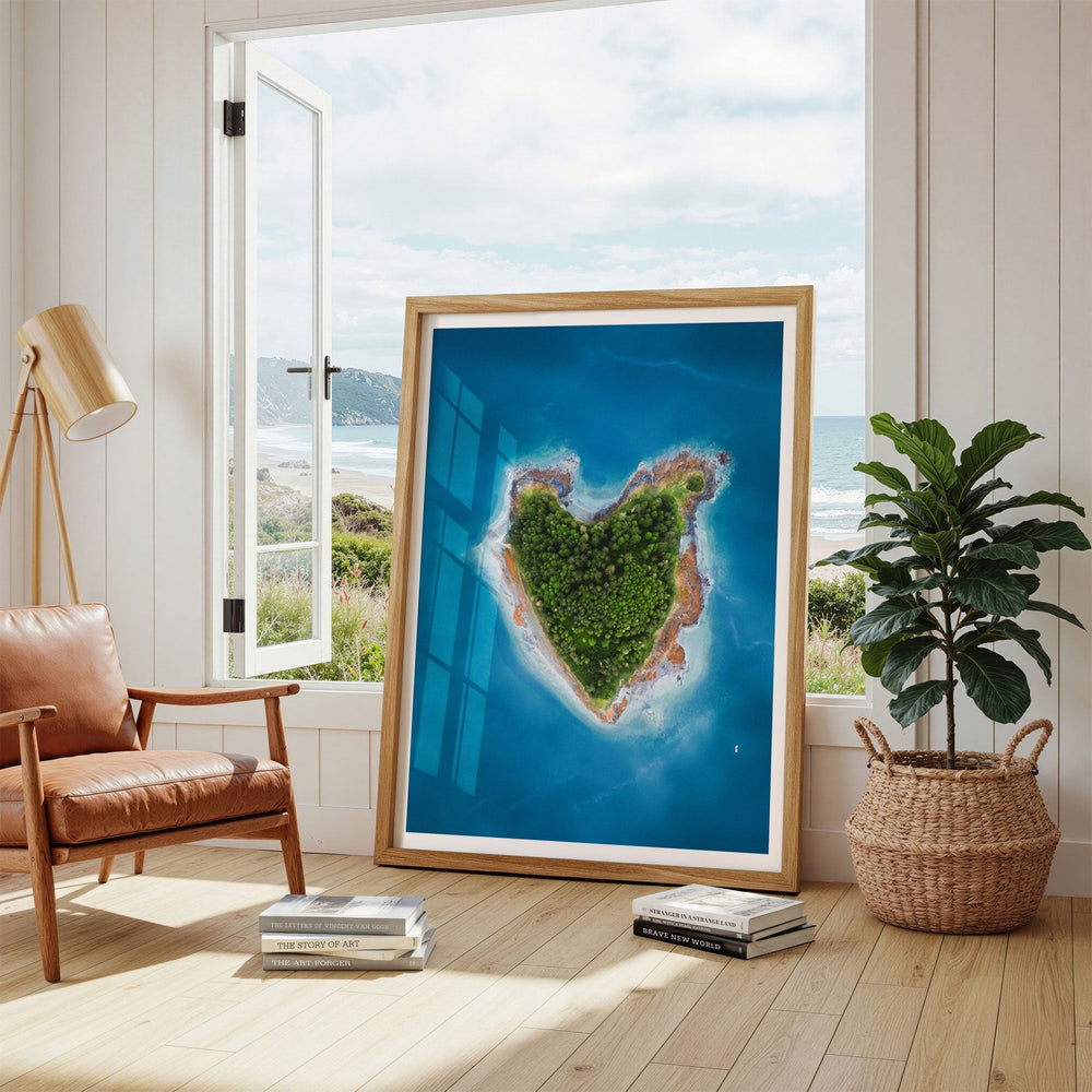 artwork of a heart-shaped island in a living room with a window view.