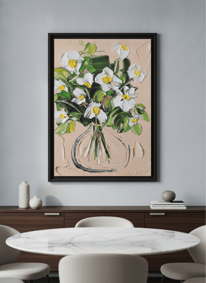 Wall art styled above a dining table in a contemporary home