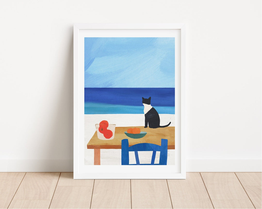 Artwork of a cat at a table with fruit, set against a blue sky and ocean.