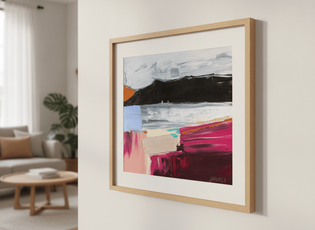 Modern wall art styled above a sofa in a neutral living room