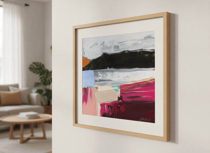 Modern wall art styled above a sofa in a neutral living room