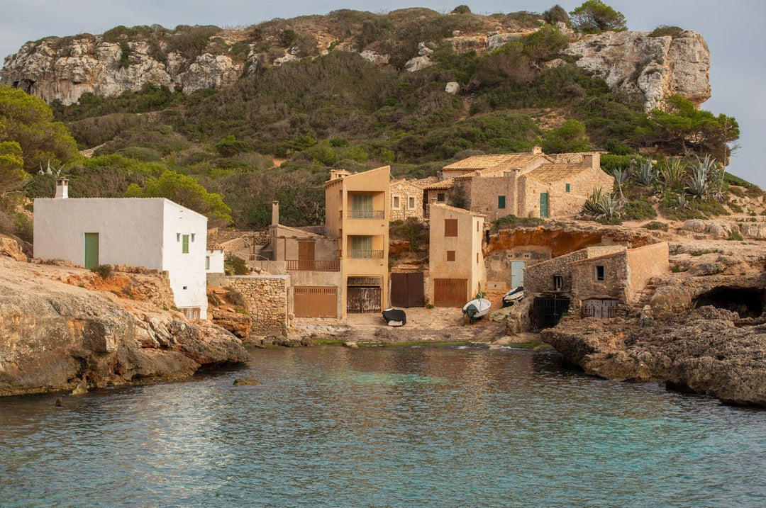 Coastal village with houses built into a cliff overlooking the sea framed