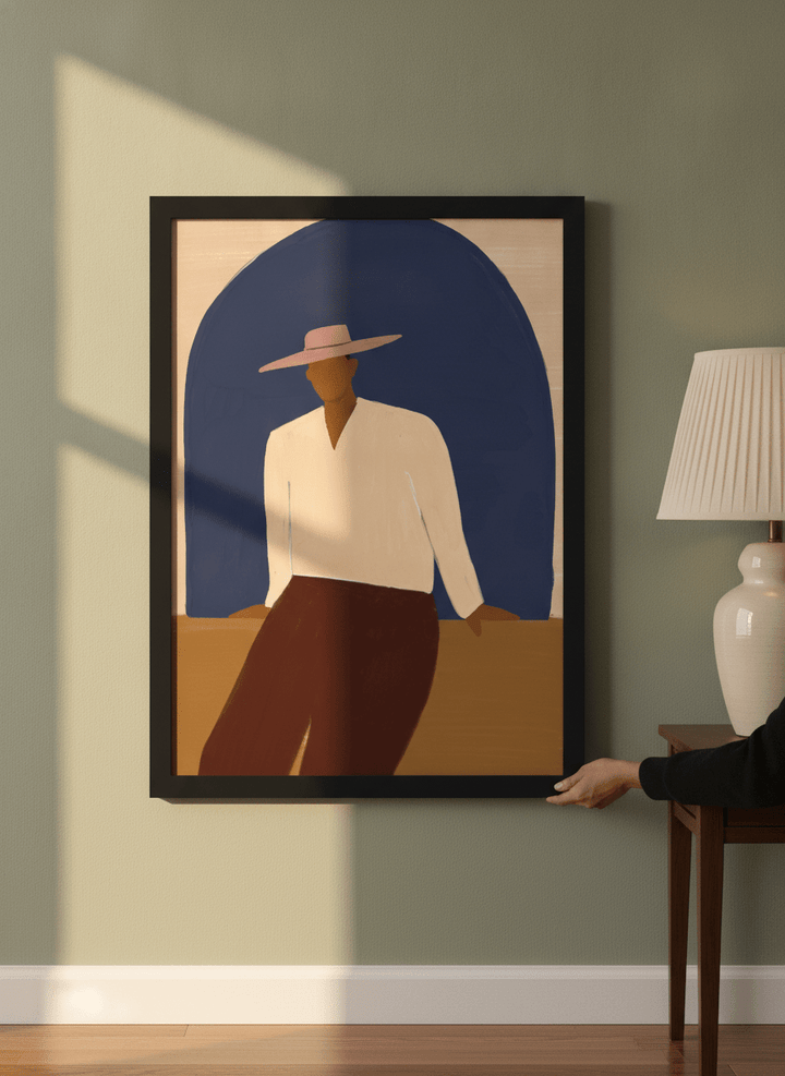 Person holding modern wall art print in a mid-century living room