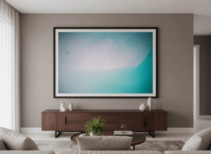 Modern wall art styled above a sofa in a neutral living room