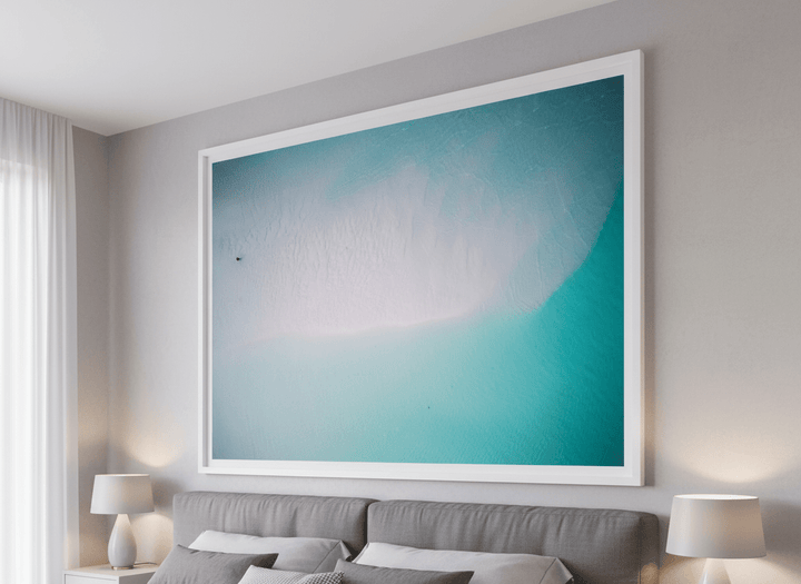 Minimalist artwork displayed in a calm, light-filled bedroom interior