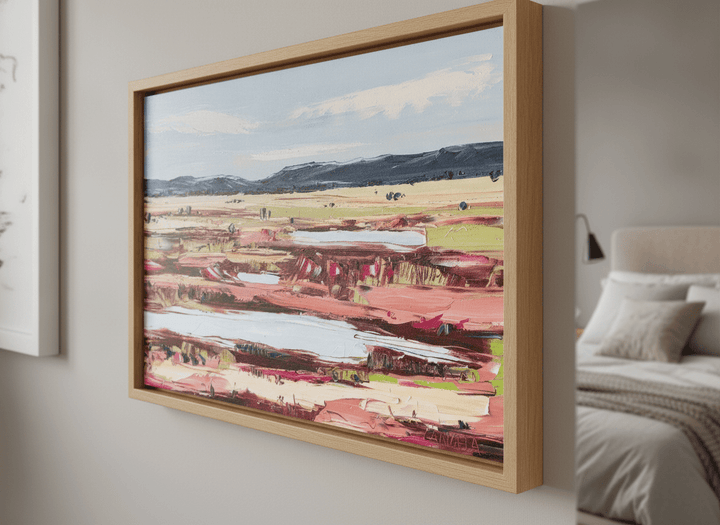 Minimalist artwork displayed in a calm, light-filled bedroom interior