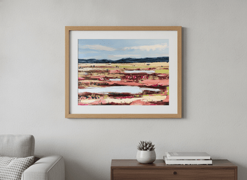 Modern wall art styled above a sofa in a neutral living room