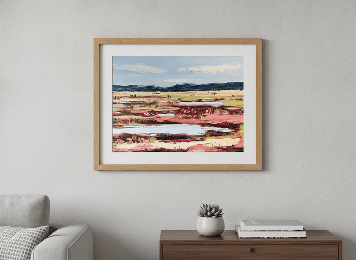 Modern wall art styled above a sofa in a neutral living room