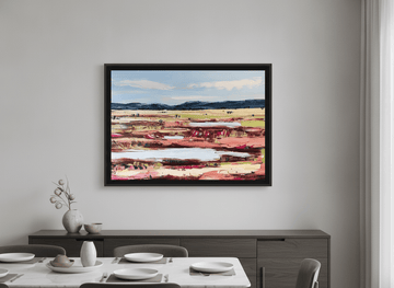 Wall art styled above a dining table in a contemporary home