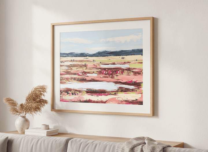 Modern wall art styled above a sofa in a neutral living room