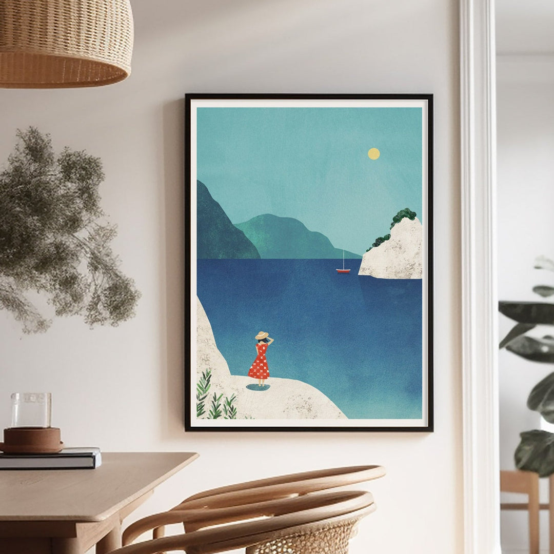 Dining room with wooden table and chairs, artwork on the wall, and natural light.