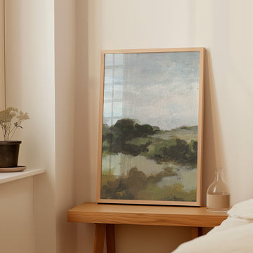 Landscape painting on a wooden side table against a beige wall.
