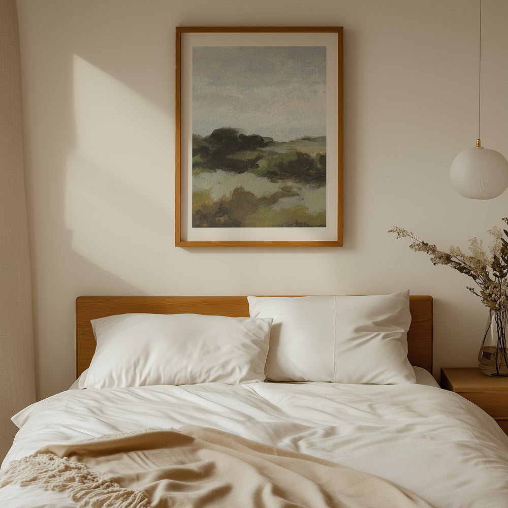 Neatly made bed with white pillows and beige blanket, artwork on the wall.