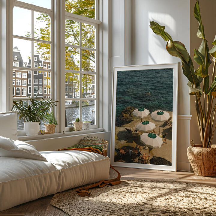 printed photo leaning against wall beside window