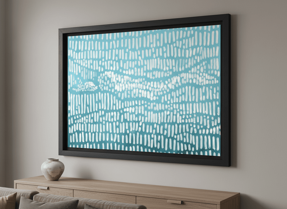 Modern wall art styled above a sofa in a neutral living room