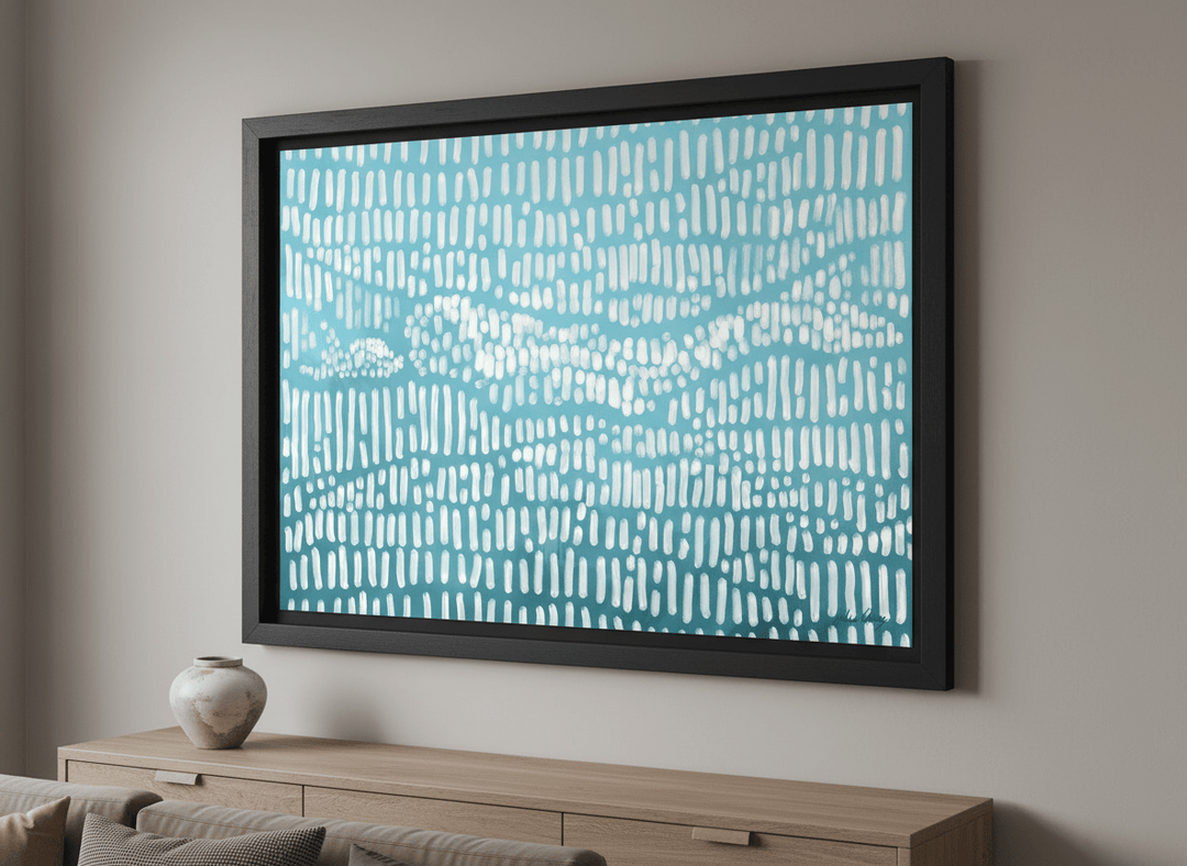 Modern wall art styled above a sofa in a neutral living room