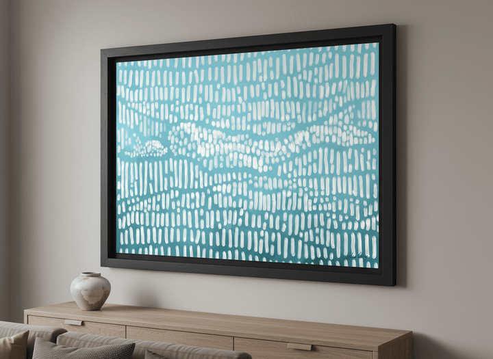 Modern wall art styled above a sofa in a neutral living room