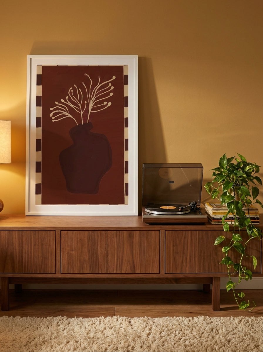 Modern wall art print standing on a sideboard in a retro 70s bedroom