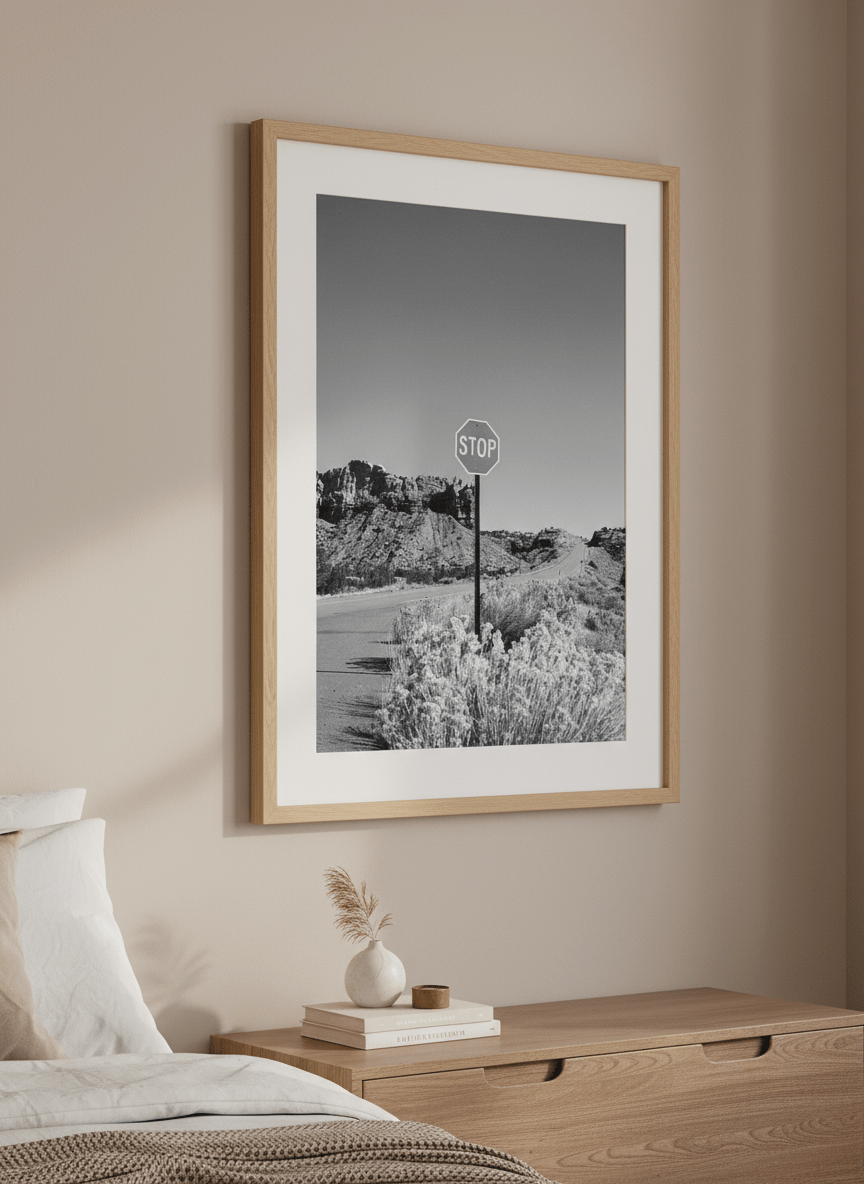 Minimalist artwork displayed in a calm, light-filled bedroom interior