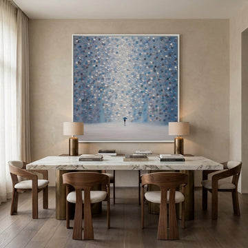 Oversized statement canvas wall art with a white surround styled on the wall in a luxe dining room