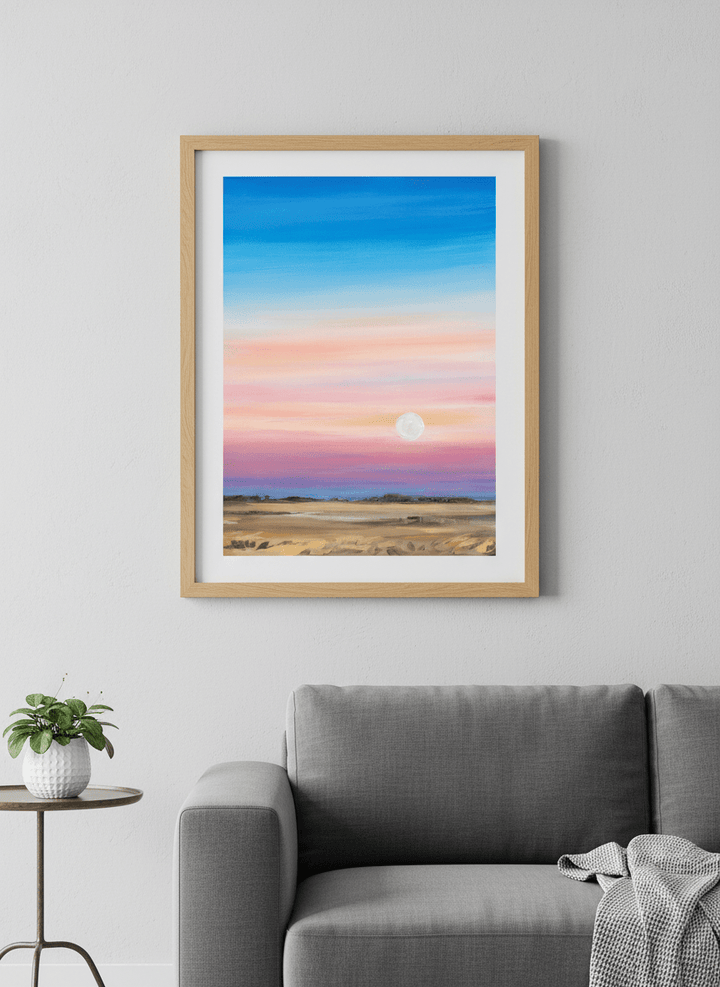 Modern wall art styled above a sofa in a neutral living room