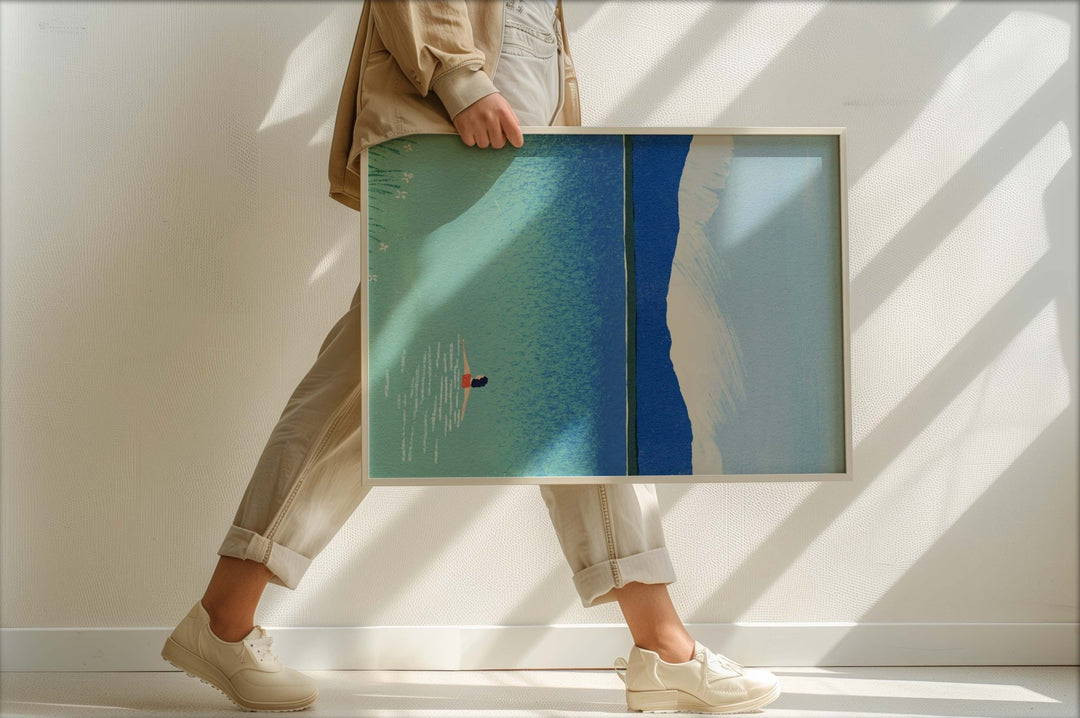 Person holding a large artwork with abstract design in a minimalistic setting