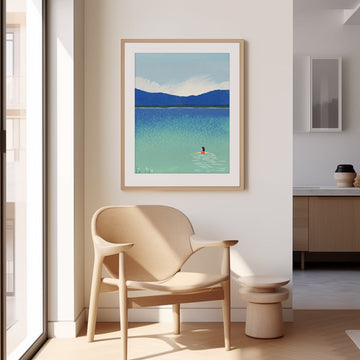 Modern interior with a chair, small table, and artwork of a person swimming in a lake.