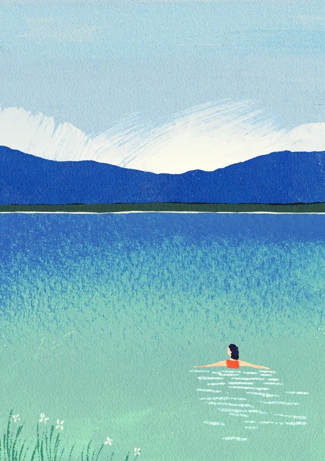 Person swimming in a lake with mountains in the background framed