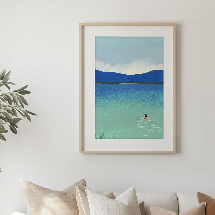 Modern living room with a white sofa, wooden coffee table, and artwork on the wall.