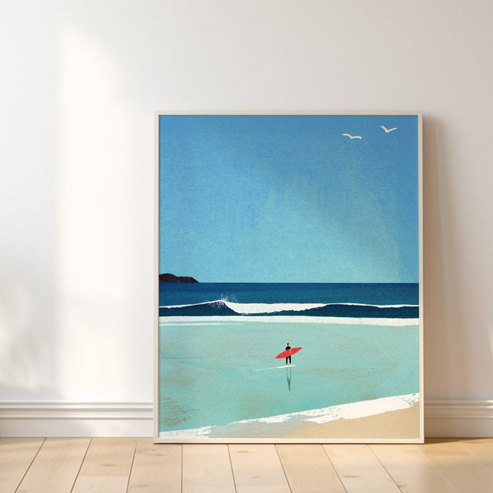 Artwork of a beach scene with a red umbrella on a white wall.