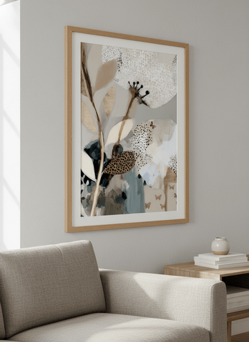 Modern wall art styled above a sofa in a neutral living room
