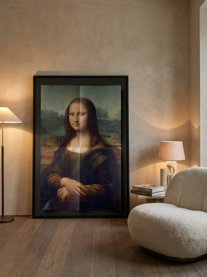 Oversized statement canvas wall art with a black surround leaning against the wall in a luxe dining room