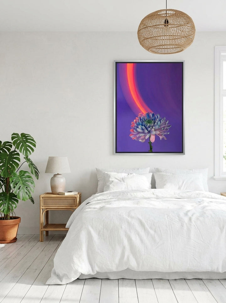 Canvas wall art with a silver leaf surround styled on the wall in a bright Scandinavian bedroom