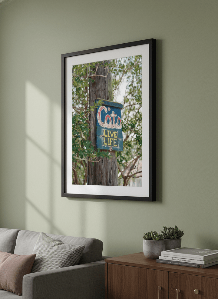 Modern wall art styled above a sofa in a neutral living room