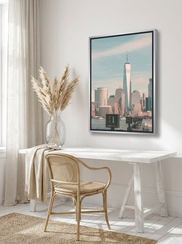 Canvas wall art with a silver leaf surround styled on the wall in a coastal home office