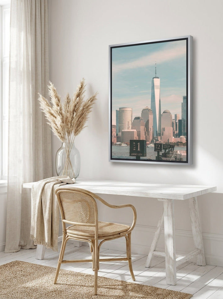 Canvas wall art with a silver leaf surround styled on the wall in a coastal home office
