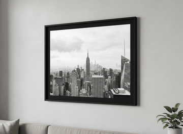 Modern wall art styled above a sofa in a neutral living room